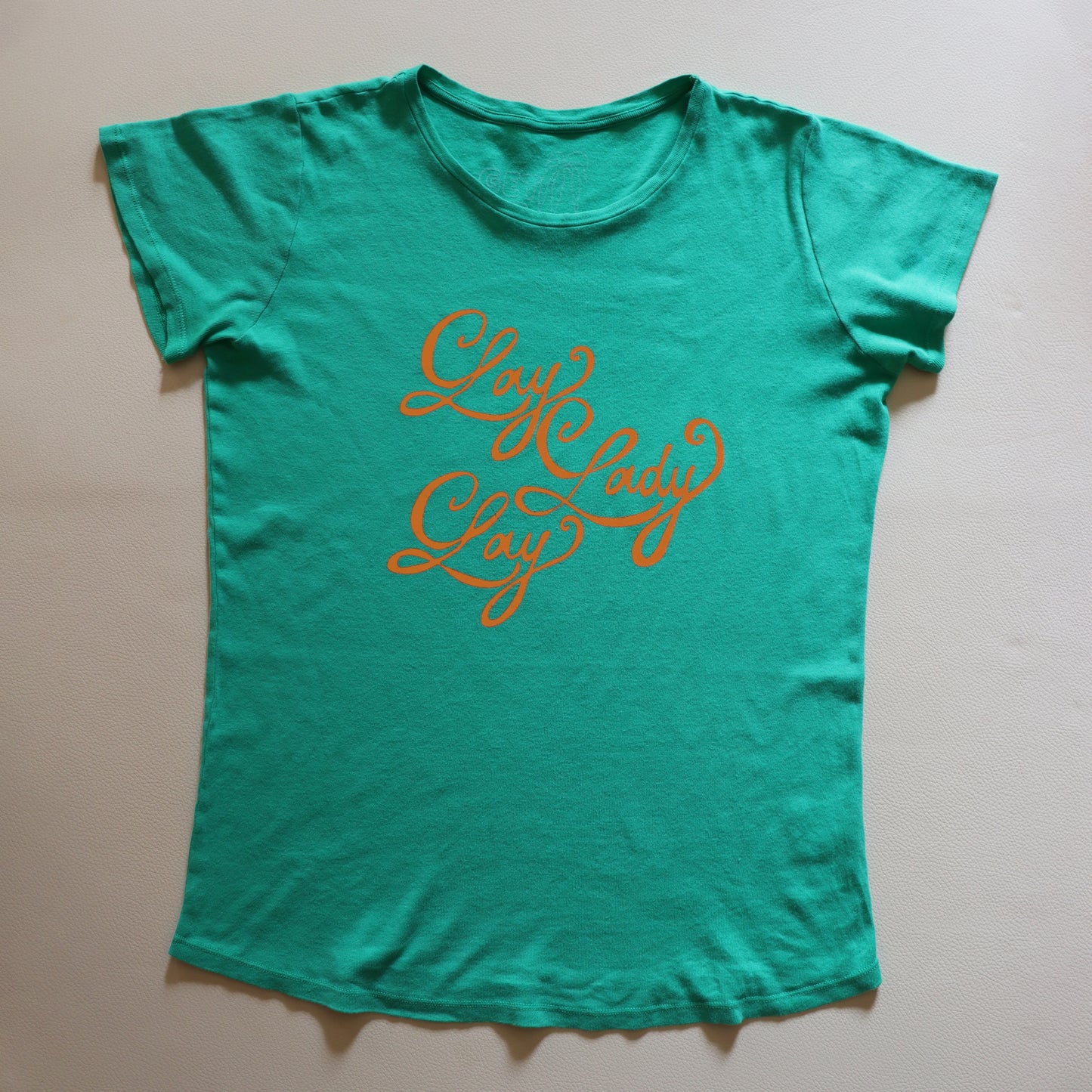 LAY LADY LAY ORANGE ON GREEN TEE SHIRT